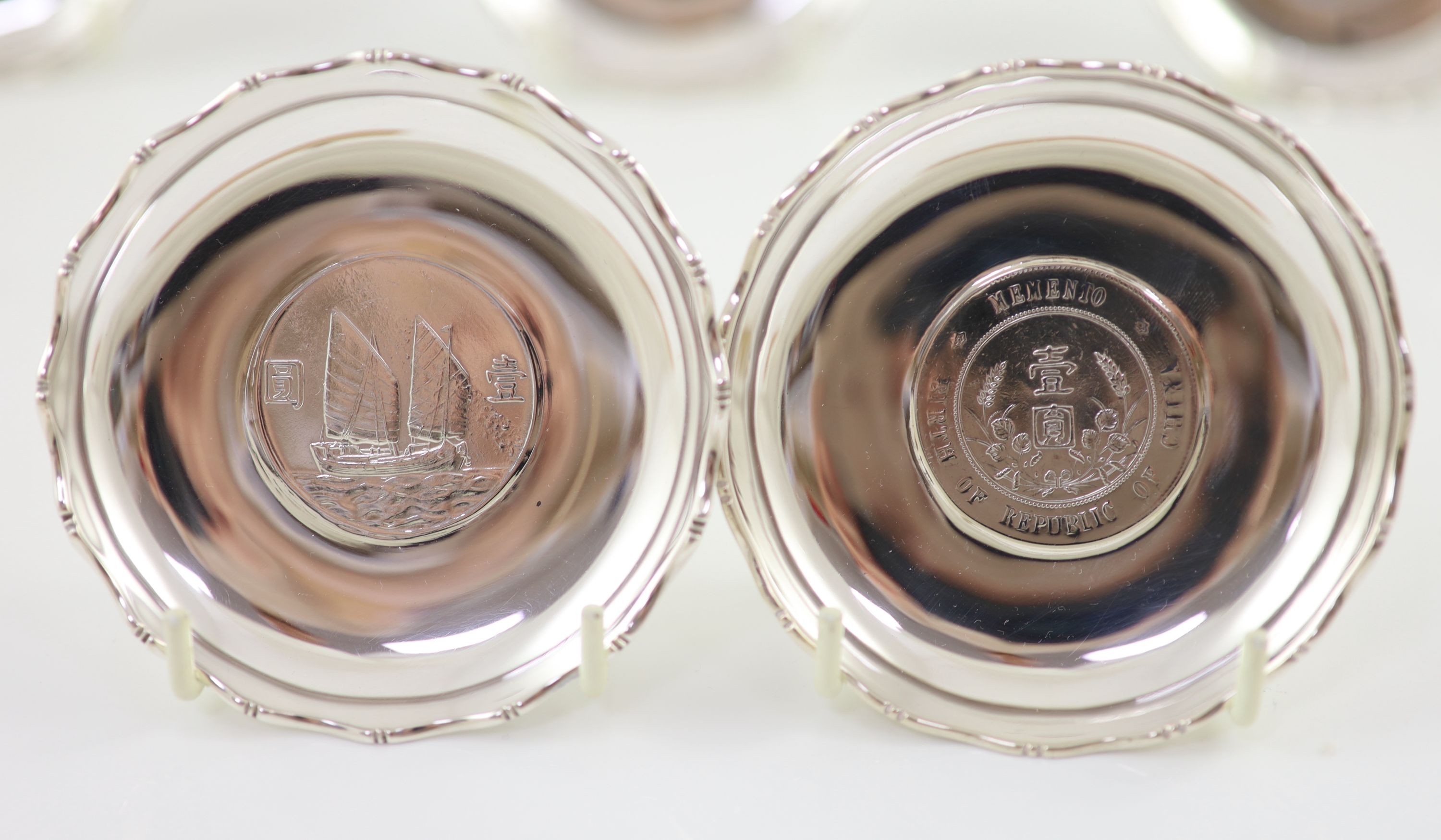 Ten early 20th century Chinese Export small Sterling silver coin inset dishes with shaped 'bamboo' edges, by Tach Hing, Hong Kong,